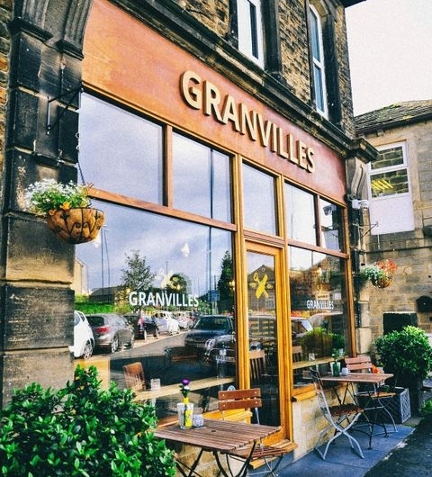 Exterior view of Granvilles Beer & Gin House with large windows, a bold sign above, and outdoor seating available on the sidewalk.