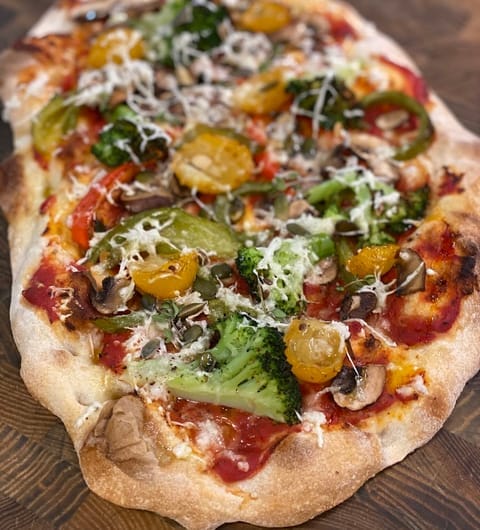 Buon Apps River Lounge — colourful vegetable pinsa romana flatbread on a wooden board