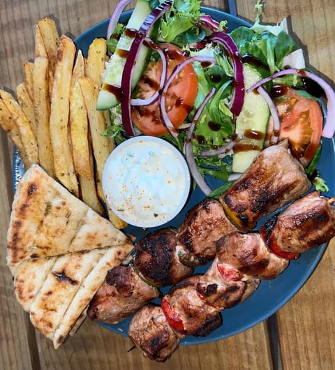 Souvlaki skewers with pitta bread, Greek salad, fries, and tzatziki at Mistreci Leeds