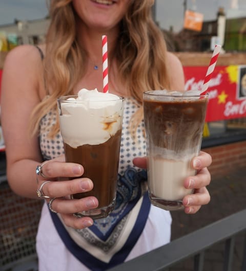 Pho 37 (Merrion Centre) — two layered Vietnamese iced coffees with red striped straws on a wooden table