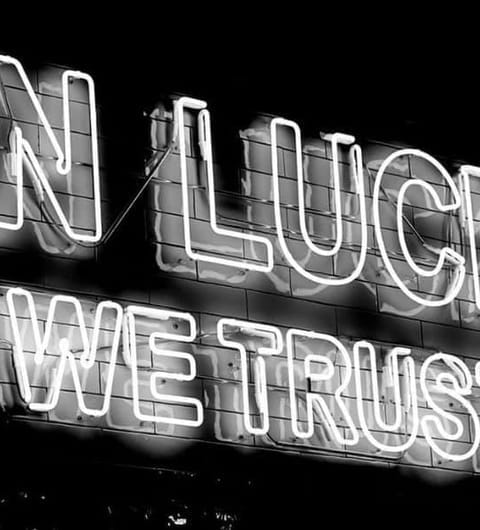 The Good Luck Club — two cocktails being toasted with cucumber and orange garnishes