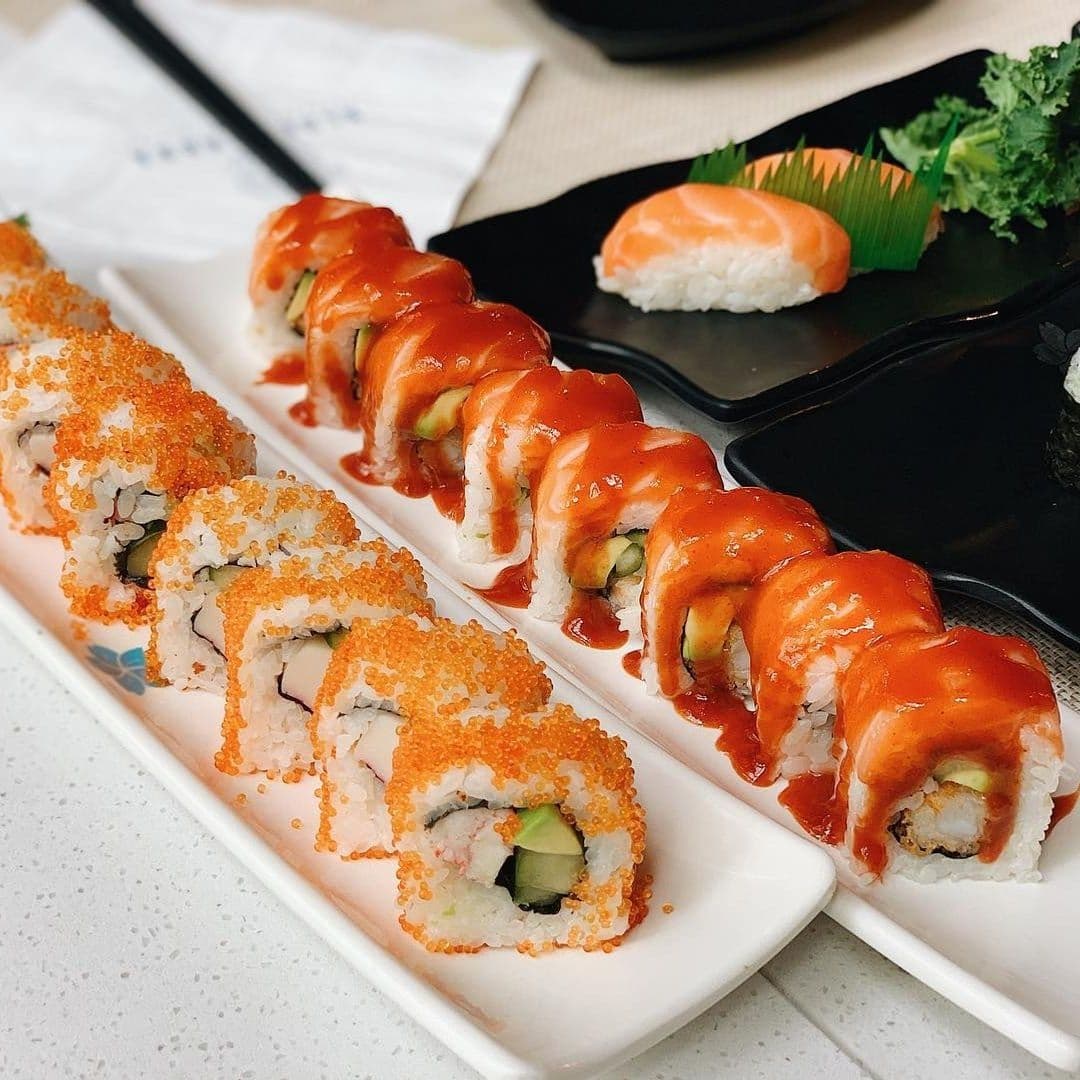 Delicious sushi rolls topped with spicy sauce and tobiko, served at Blue Sakura.
