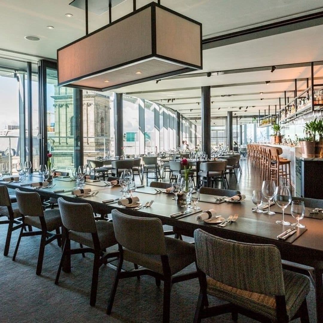 Elegant dining setup at Crafthouse with neatly arranged tables, modern chairs, and floor-to-ceiling windows offering ample natural light.