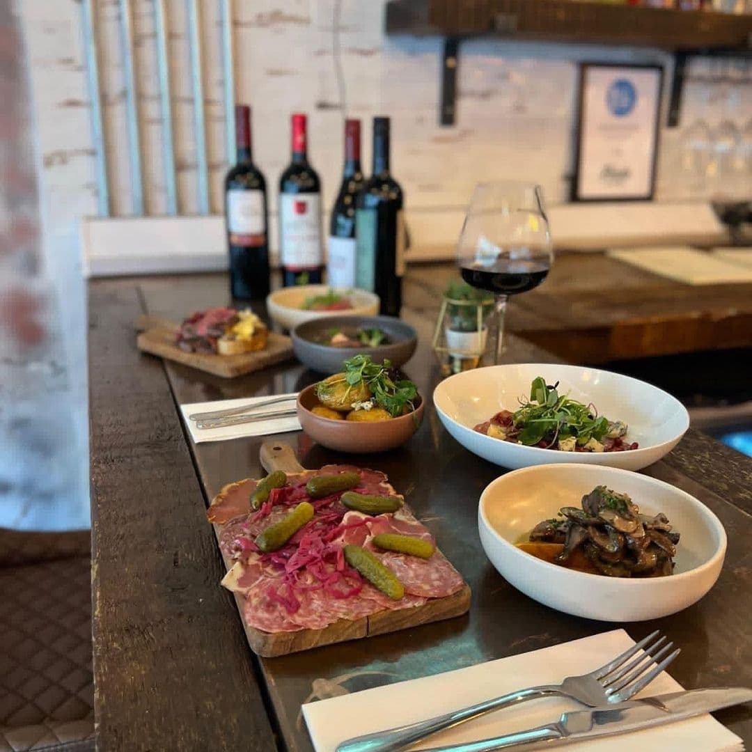 Gourmet dining experience in Forde with a selection of charcuterie, cheese, and small dishes paired with red wine.