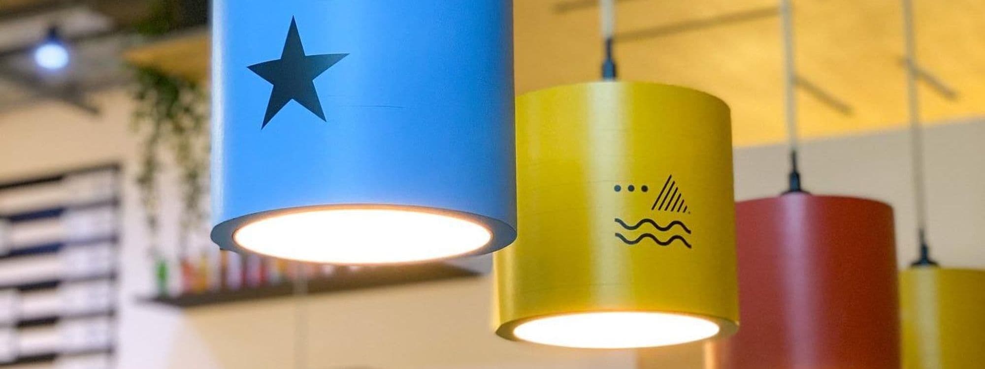Colorful hanging pendant lights with decorative motifs at North Star Coffee Shop.