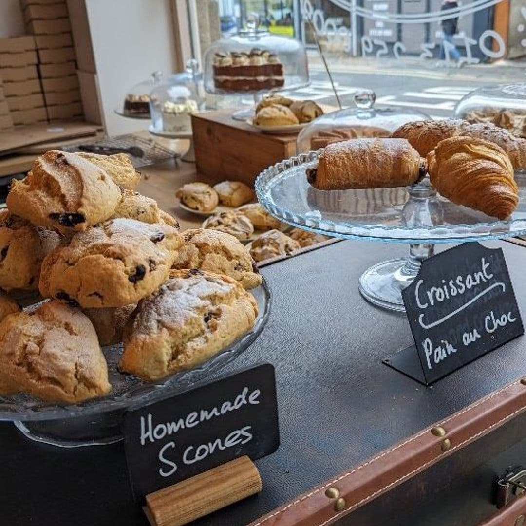 Assorted freshly baked goods on display at Truly Scrummy, featuring homemade scones, croissants, and pain au chocolat, with a clear focus on the quality and variety of the pastries offered.