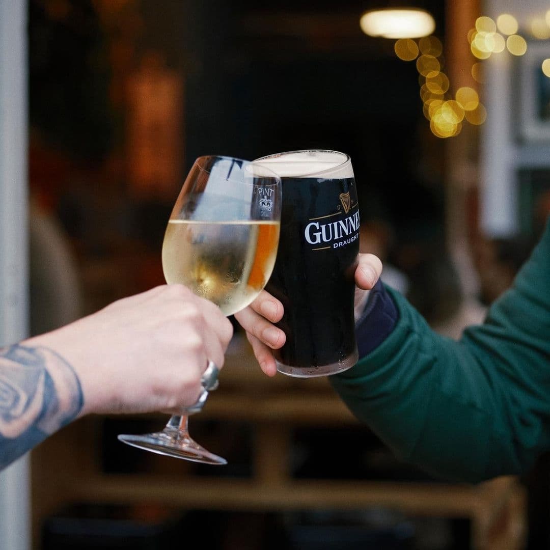 Close-up of a toast with a pint of Guinness and a glass of white wine at The Brunswick.