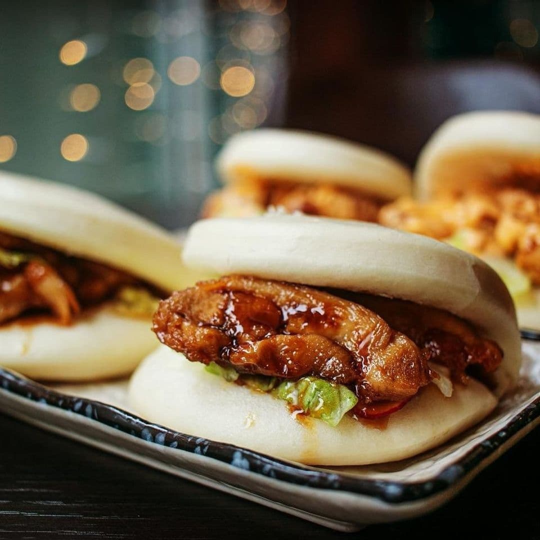 Delicious Asian-style steamed buns filled with glazed chicken and fresh greens served at Sushi Waka.