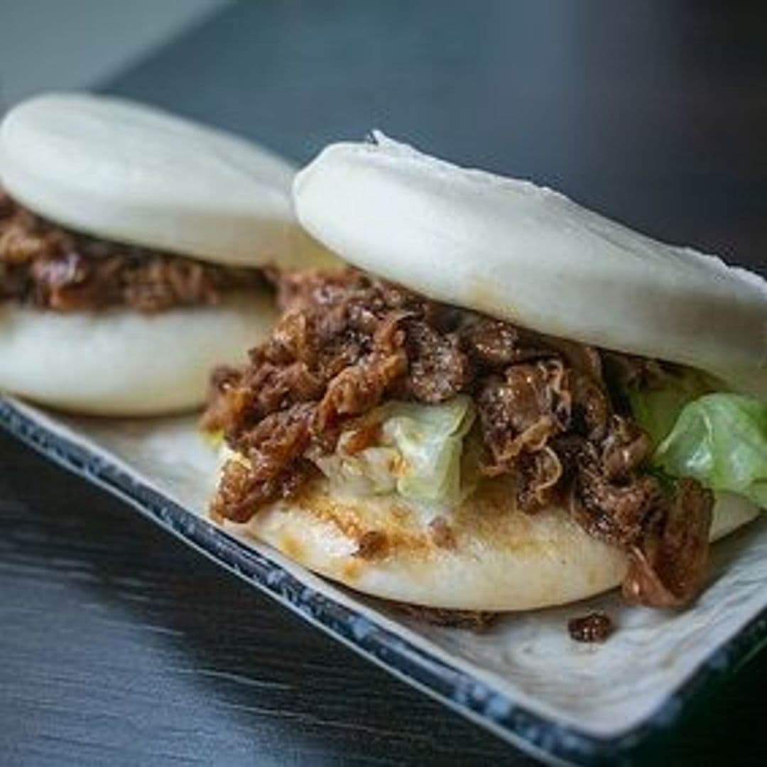 Savory bao bun filled with succulent meat and crisp lettuce served at Sushi Waka.