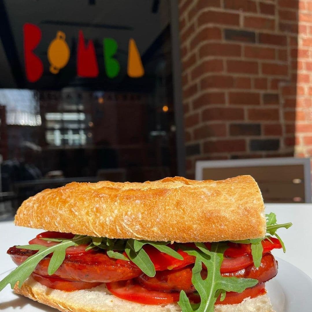 Freshly made chorizo sandwich with tomato and arugula on a crusty baguette at The Cross Keys.