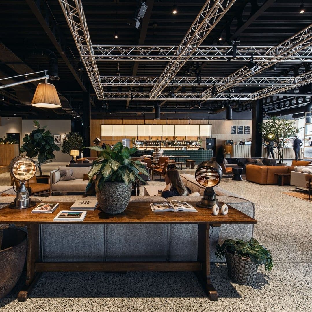 Interior of Fearns Dock lounge area with modern furniture, pendant lighting, and guests relaxing.