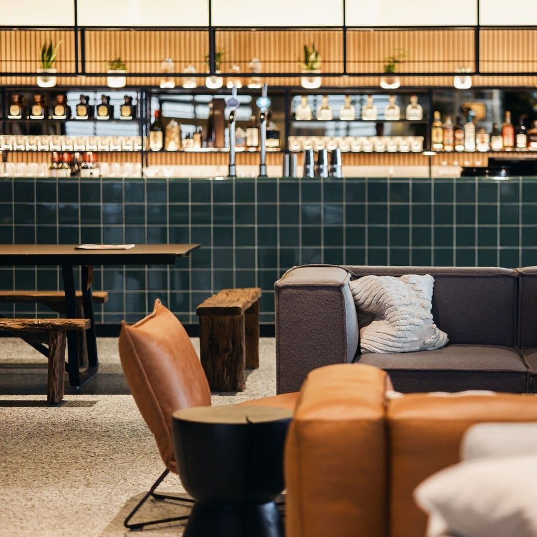 Cozy lounge area at Fearns Dock with comfortable seating and stylish bar in the background.