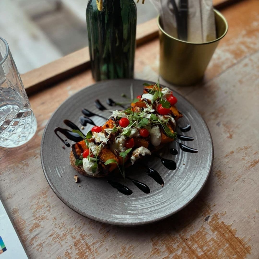 Gourmet bruschetta with vibrant toppings served on a gray plate at Mill Kitchen & Bakery.