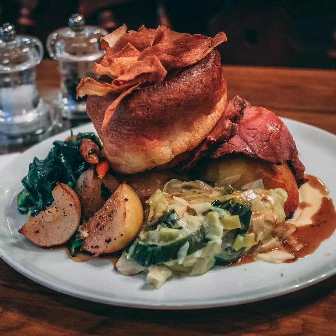 Traditional Sunday roast with Yorkshire pudding, beef, roasted potatoes, and vegetables served at Gascoigne Arms.