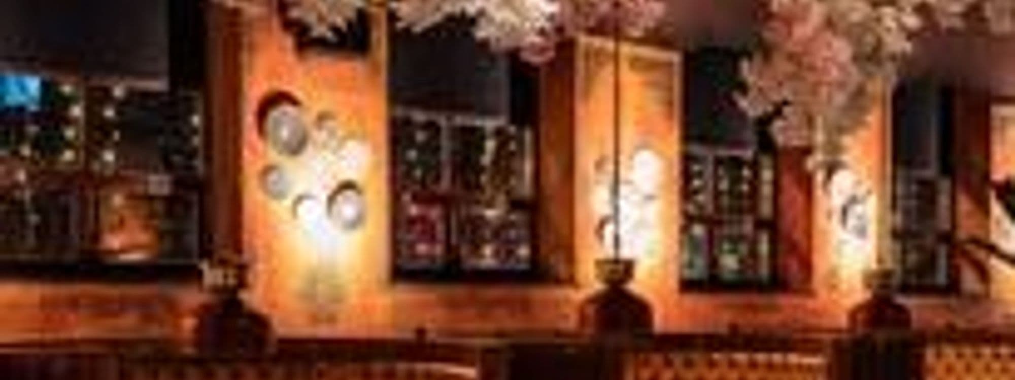 Alt text: Interior view of Kerala Canteen, featuring warm lighting, decorative wall art, and elegant furnishings that create a cozy dining atmosphere.