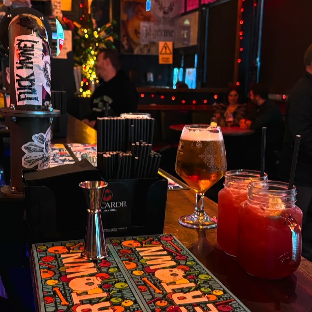 Colorful bar scene with drinks, vibrant decor, and patrons enjoying the lively atmosphere at Santiago Bar.