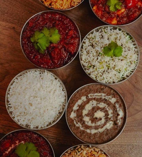 Overhead spread of Indian curries, rice and dal at Aarti Indian Restaurant Leeds