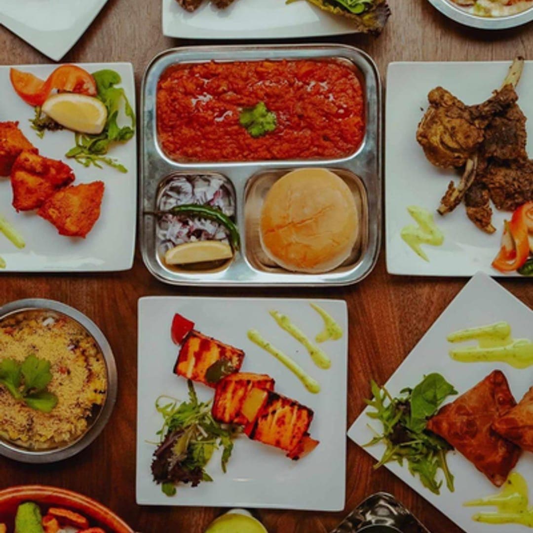 Assortment of Indian starters including mixed grill, kebabs and sauces at Aarti