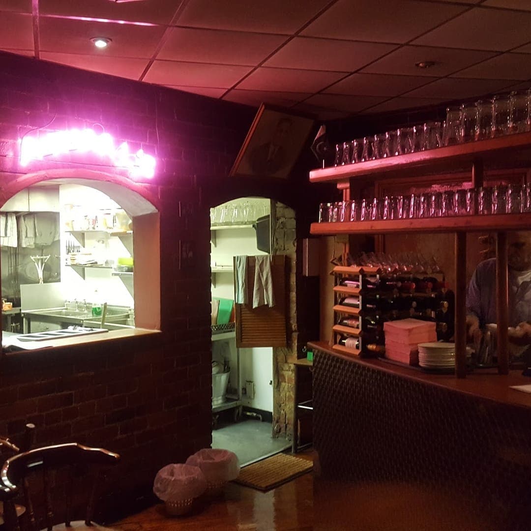 Akmal's Tandoori Bistro — bar area with pink neon lighting