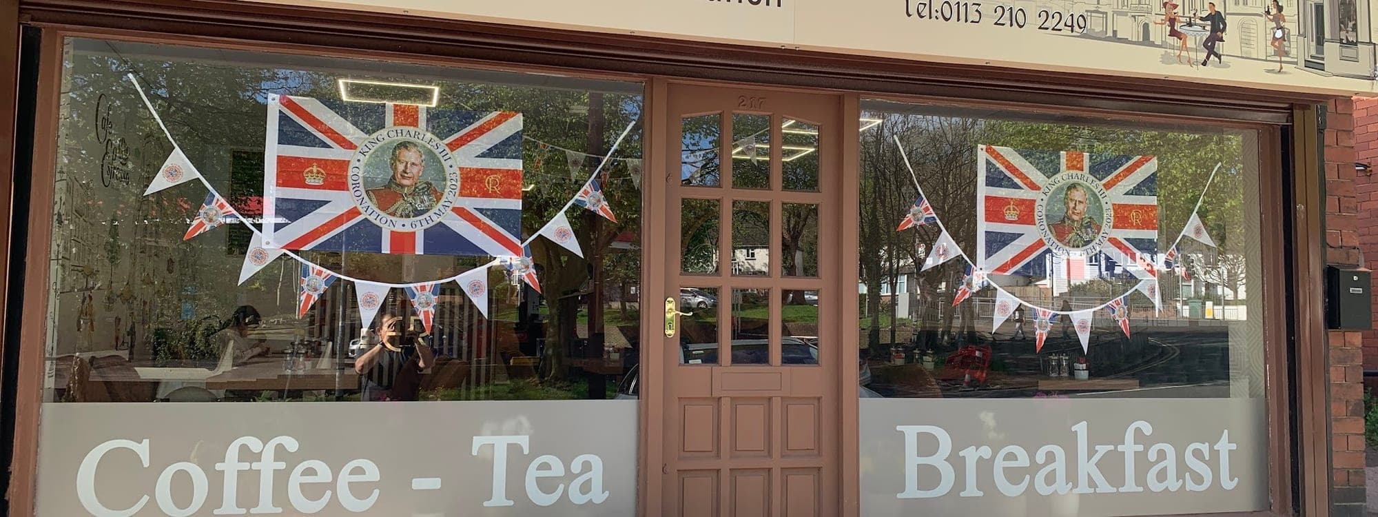 Cafe Espresso — exterior storefront with sign and bunting decorations