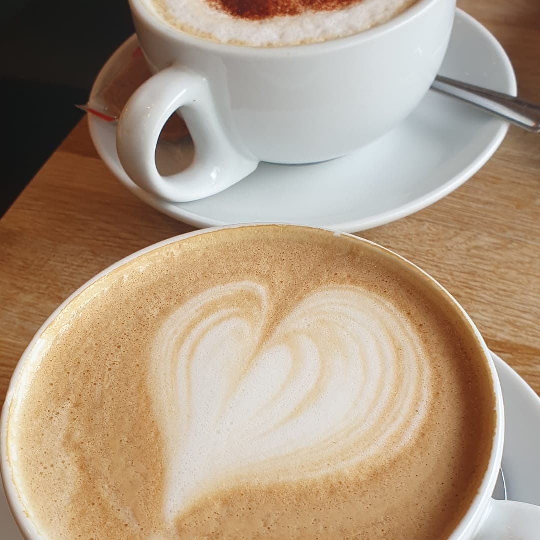 Cafe Espresso — two cappuccinos with latte art