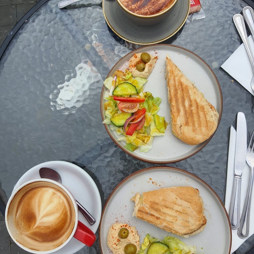 Cafe Espresso — overhead view of table with paninis and coffees