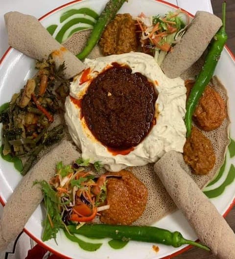 Ethiopian fasting platter with injera, stews, and fresh vegetables at Abashawel Leeds