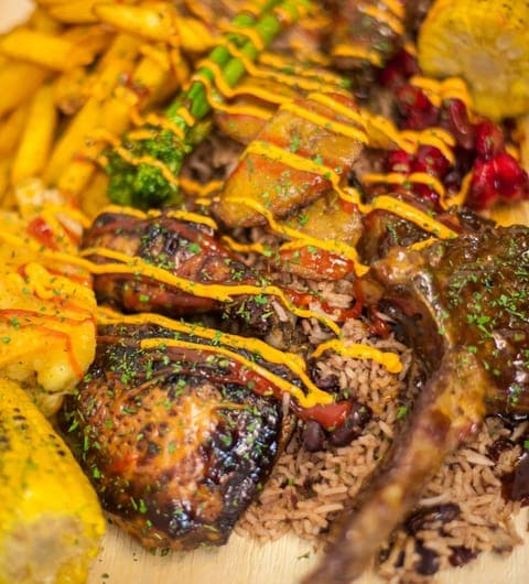 Jerk chicken with rice and peas drizzled with sauce at Chef Shabbas Kitchen Leeds