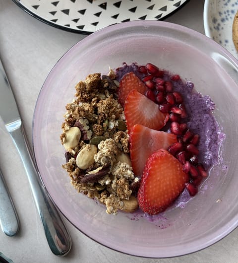 Acai bowl topped with strawberries, pomegranate, and granola at Hyde Cafe and Bar Leeds