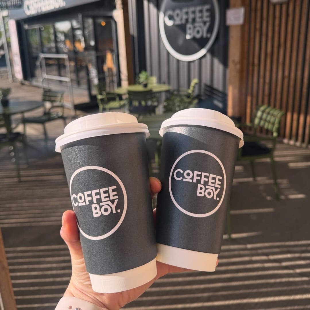 Two Coffeeboy branded cups side by side