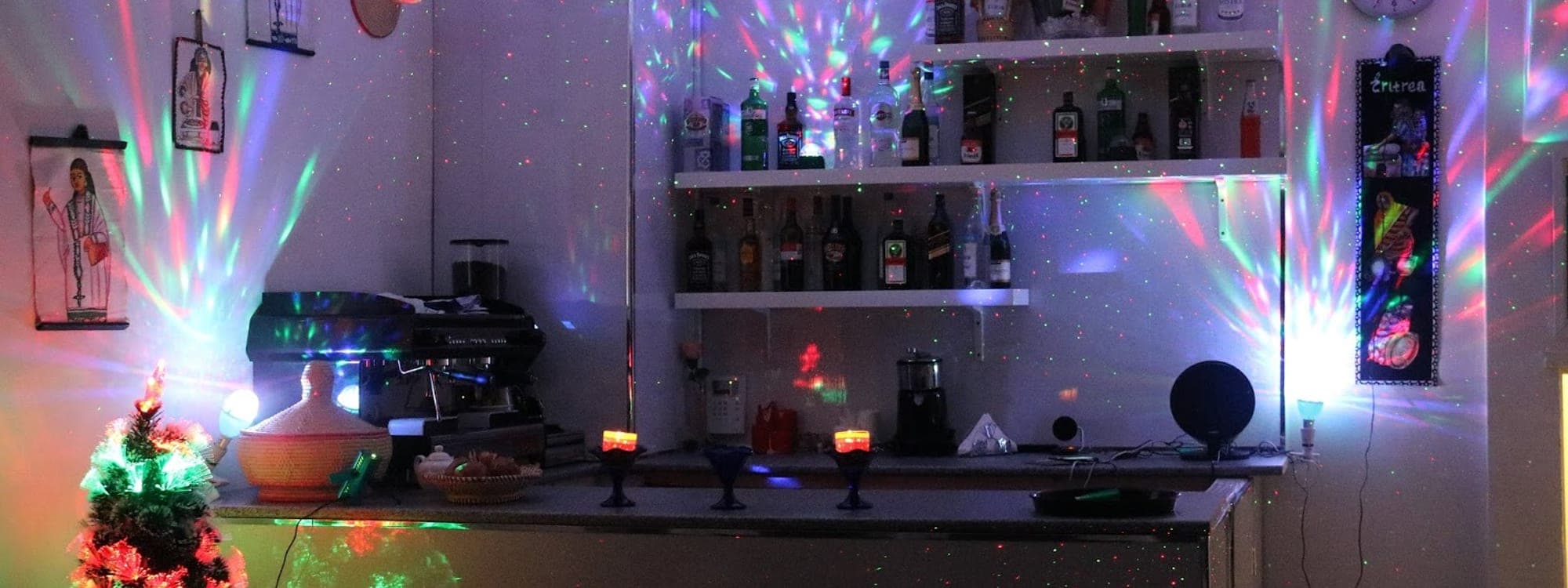 Interior of Abashawel Restaurant Leeds showing bar area with colourful lights and festive decor