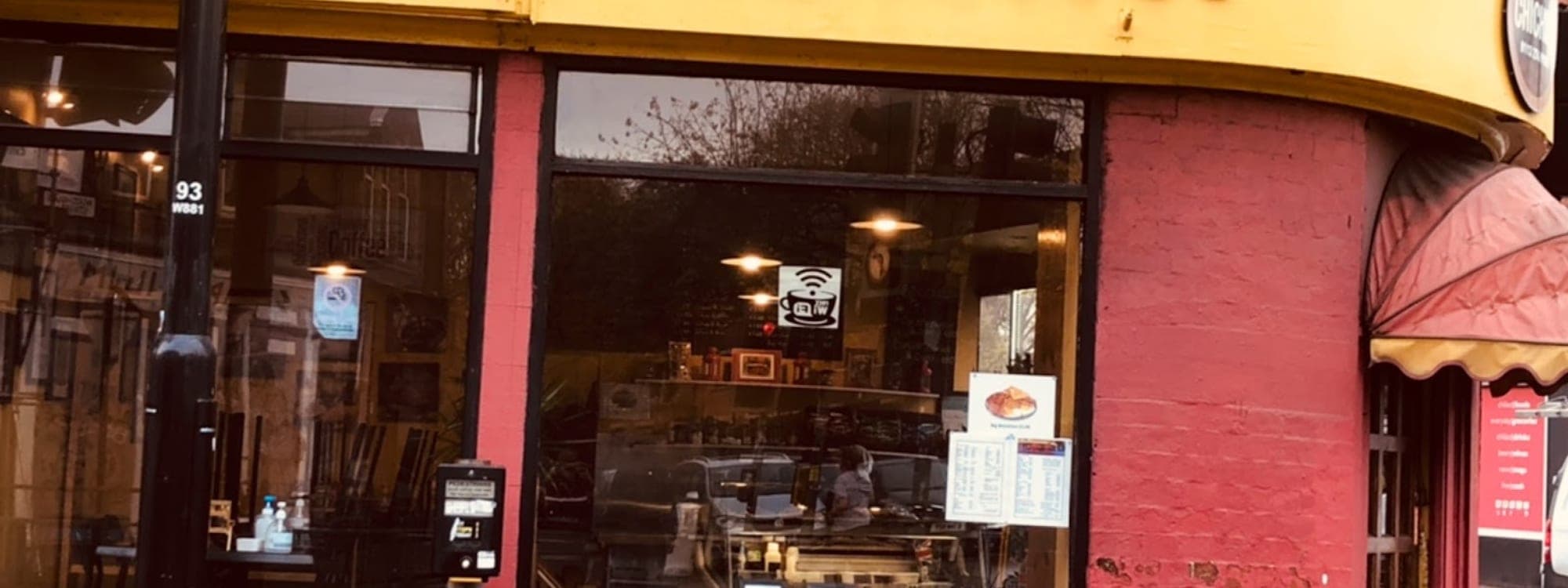 Yellow exterior of Chichini cafe with signage and chalkboard menu on Hyde Park Road Leeds