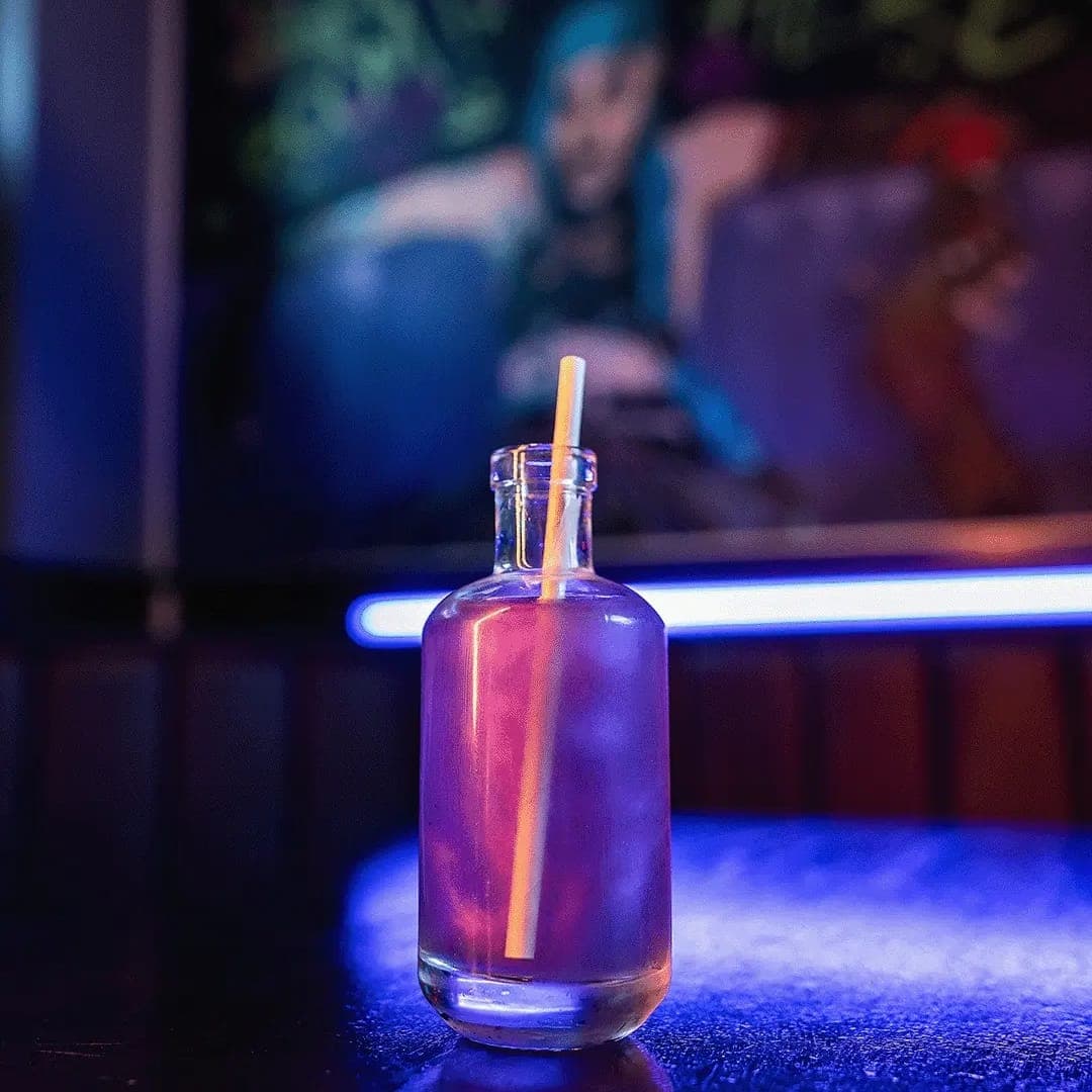 Cocktail in glass bottle on glowing blue LED bar counter at Pixel Bar Leeds