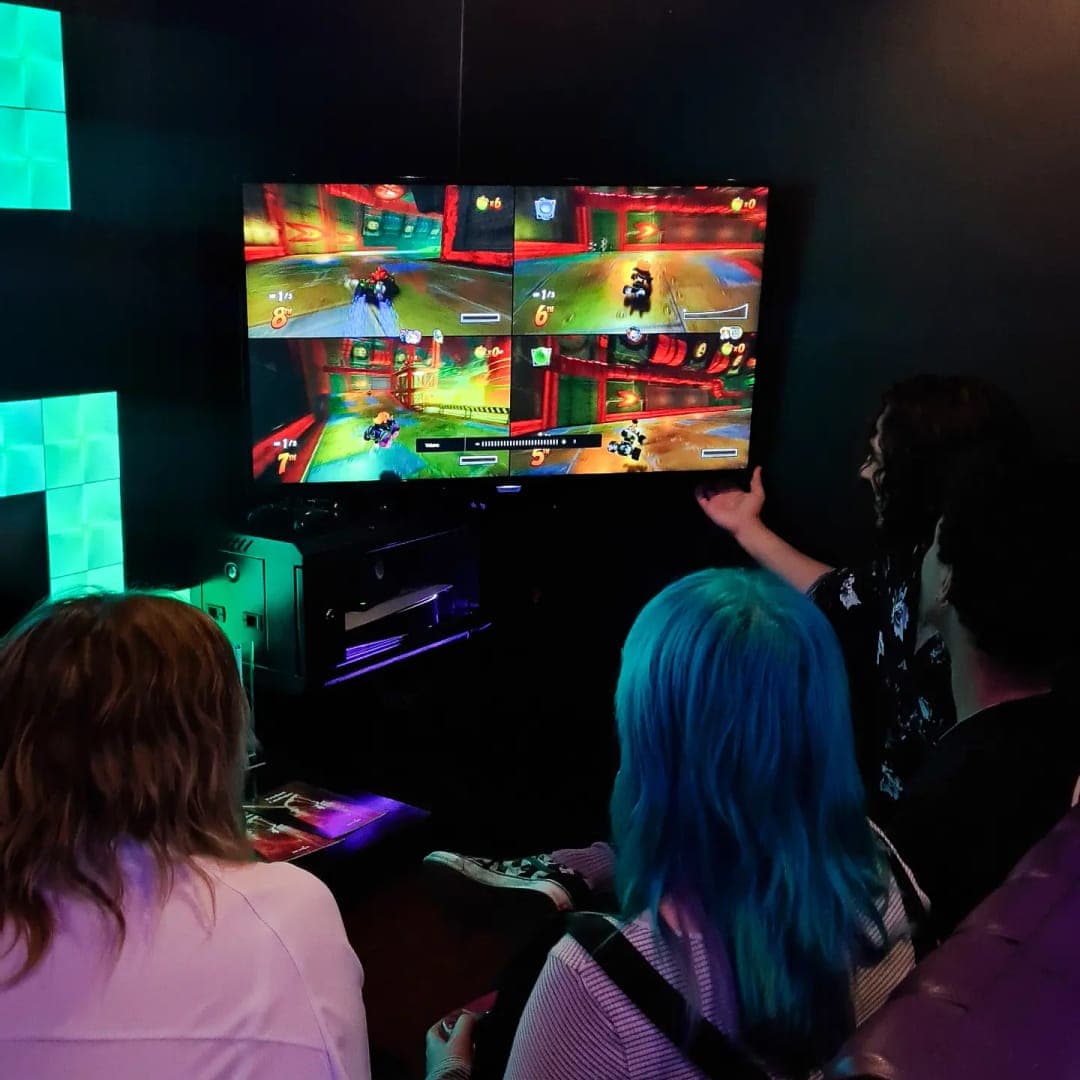 Guests playing Mario Kart at gaming booth in Pixel Bar Leeds