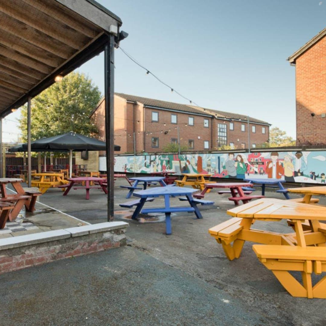 Colourful picnic benches in the beer garden at The Royal Park Leeds