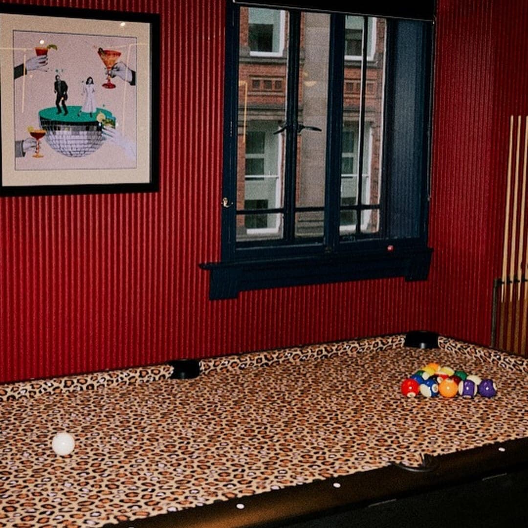 Interior of Ritas Beer Hall Leeds showing checkered floor and leopard print carpet