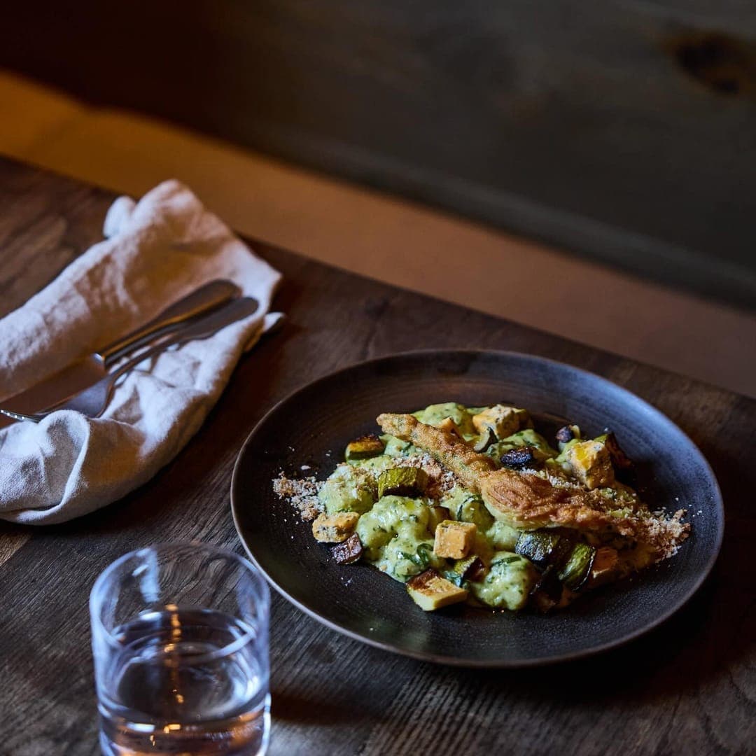 The Penny Bun — gnocchi dish on dark plate with whisky glass