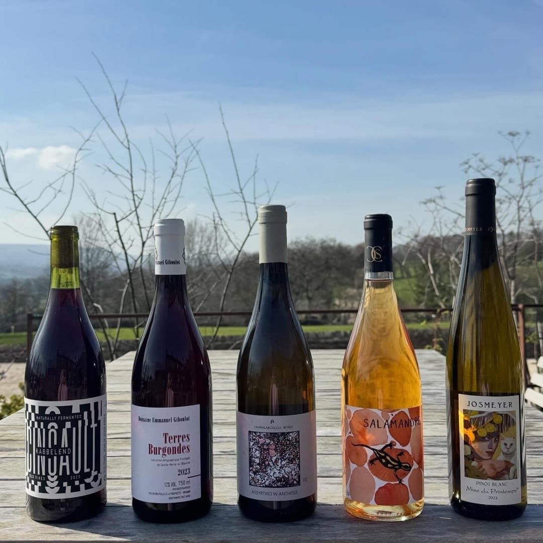 The Penny Bun — five wine bottles lined up on outdoor terrace with Yorkshire countryside