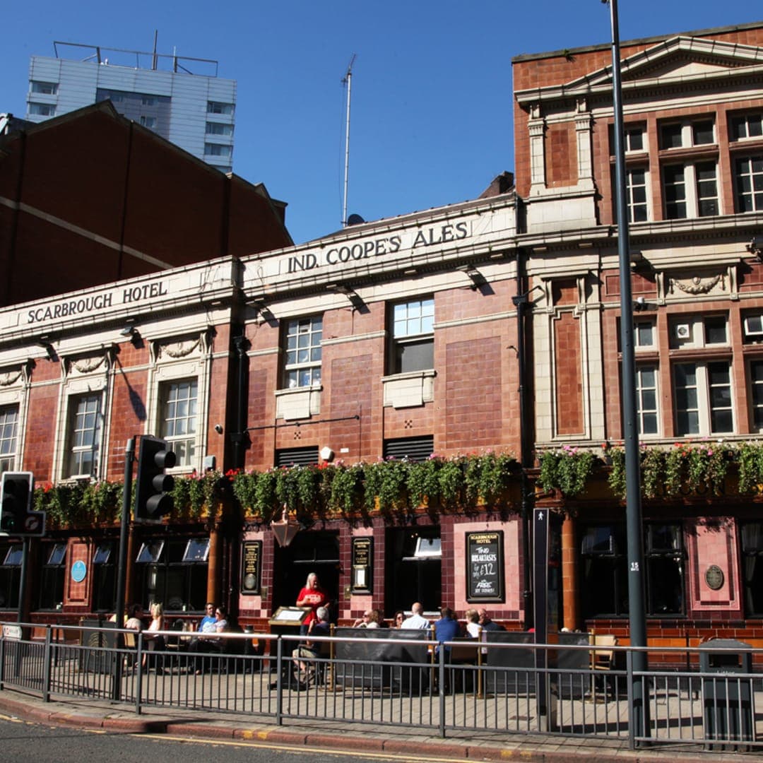 The Scarbrough Hotel — wide exterior showing the full Grade II listed building beside Leeds City Station