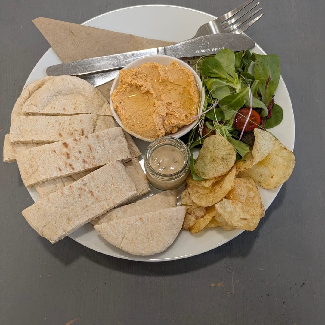 Hummus and pitta bread plate with salad and crisps at 21 Co.