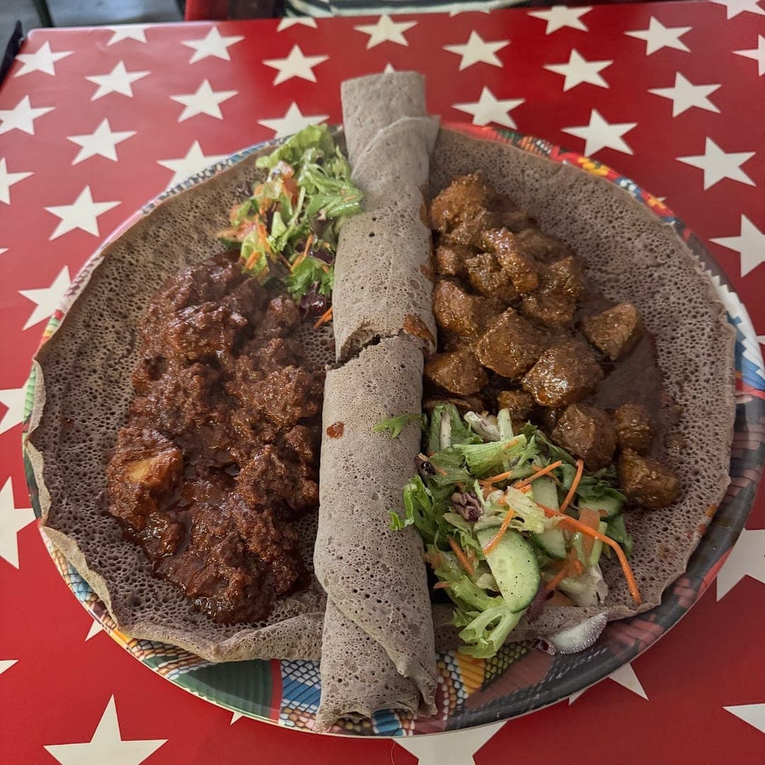 Ethiopian meat platter with injera and fresh salad at Abashawel Leeds