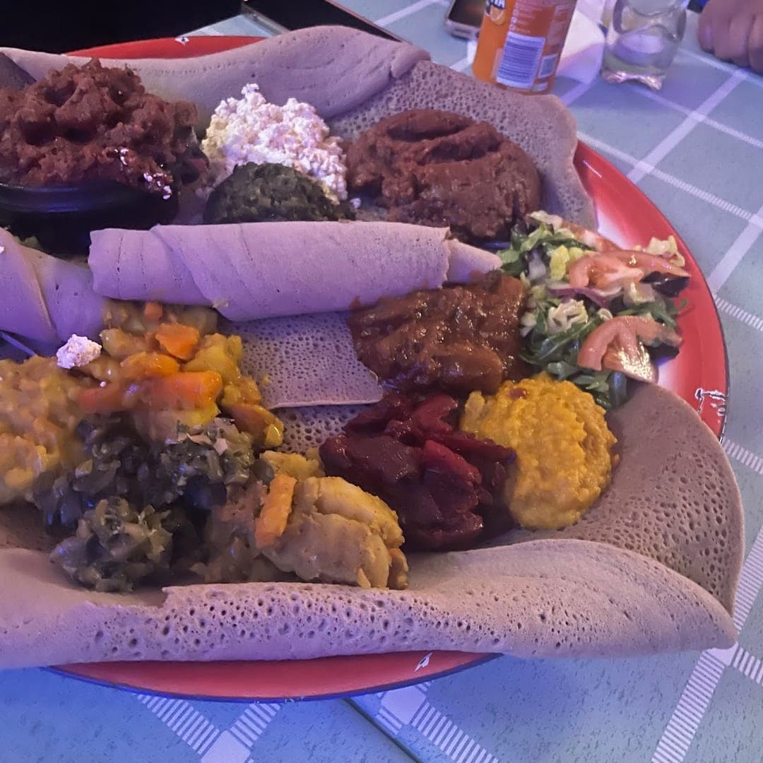 Large Ethiopian sharing platter with mixed stews on injera at Abashawel