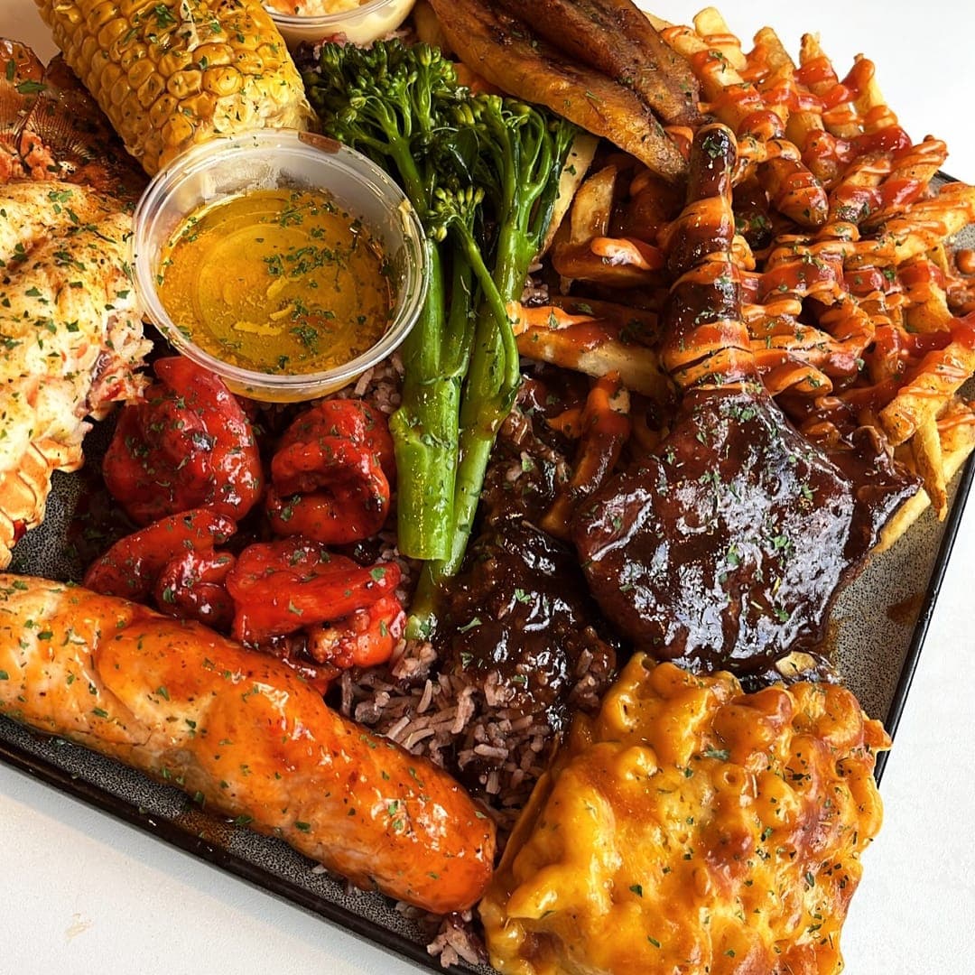 Loaded mixed platter with lobster, salmon, halloumi, broccoli, and fries at Chef Shabbas Kitchen