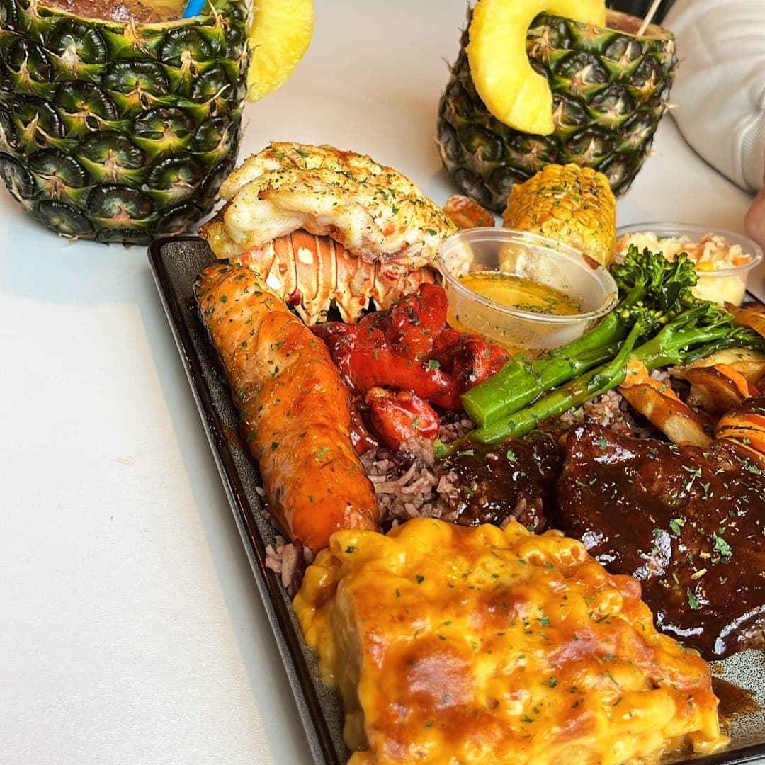 Close-up of Chef Shabbas sharing platter showing grilled meats and sides