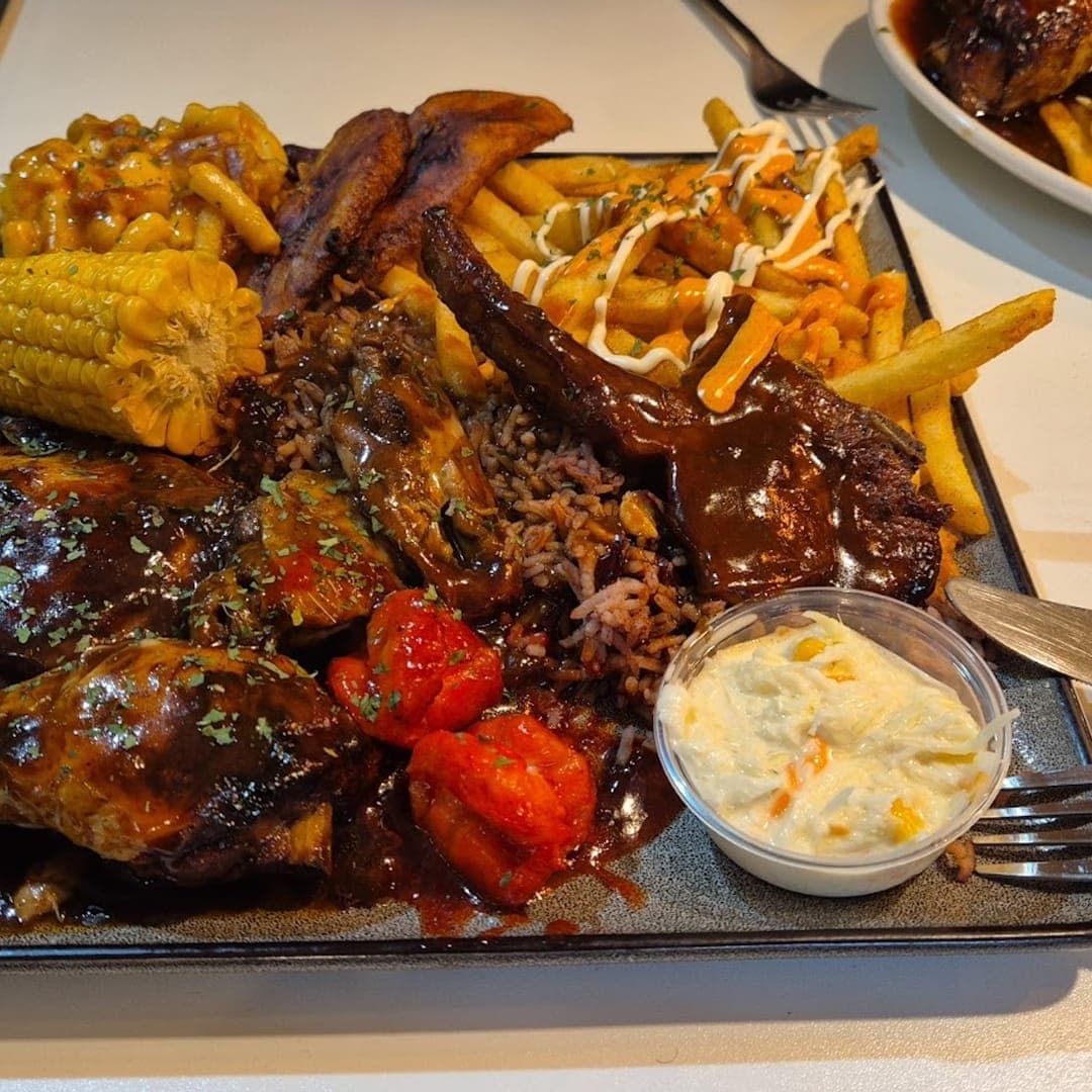 Loaded meat platter with ribs, corn, fries, and coleslaw at Chef Shabbas Kitchen