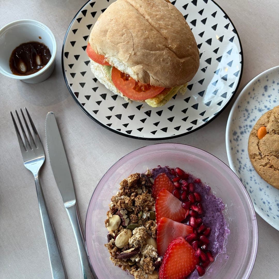Brunch spread with sandwich, acai bowl, and cookie at Hyde Cafe and Bar