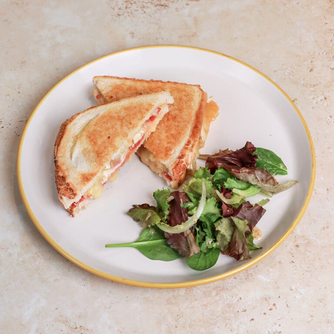 Toasted sandwich with side salad on a white plate at Lento Cafe Leeds