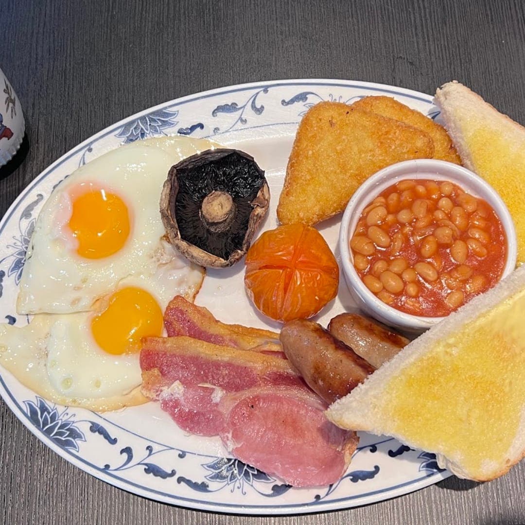 Full English breakfast with eggs, bacon, beans, hash brown, and toast at Lento Cafe