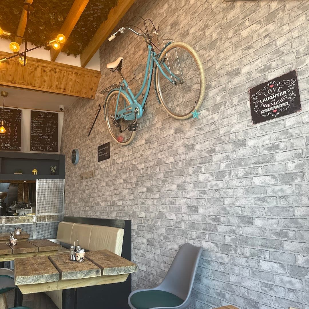 Interior of Mistreci with vintage bicycle wall decor and Be Our Guest sign
