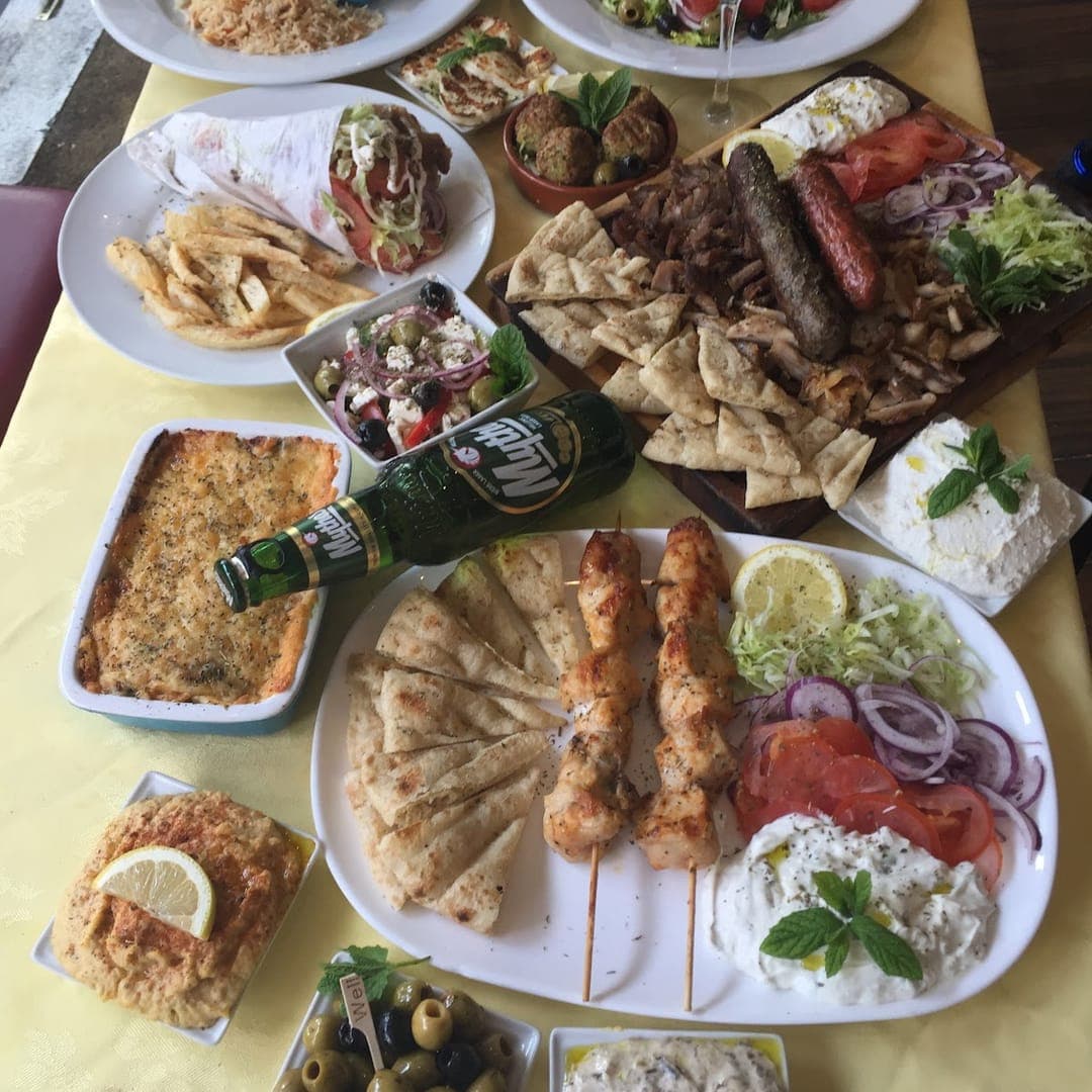 Greek feast spread with kebabs, pitta, olives, dips, and wine at Mistreci Leeds